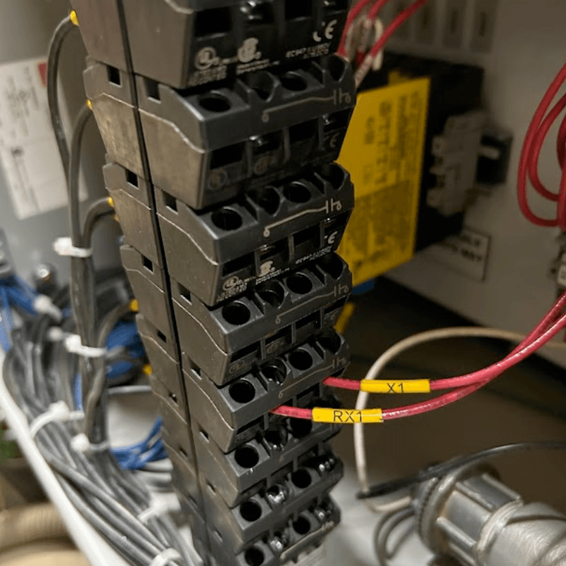 Electrical commissioning engineer conducting operational testing on PLC systems